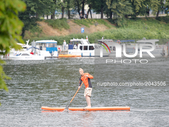 A standup paddleboarder is seen during a competition on the Brda river in Bydgoszcz, Poland Locally made cheeses are seen for sale during a...