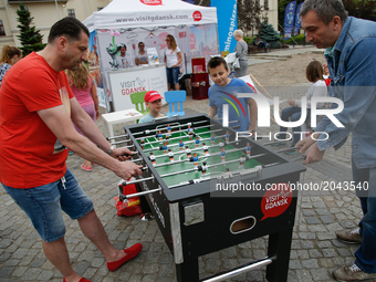 People are seen playing table football at a promotion stand for the city Gdansk in the center of Bydgoszcz, Poland A Toyata car with both pe...