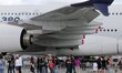 Visitors walk on the tarmac in front of  a Airbus A380 on the last day of the Internationa...