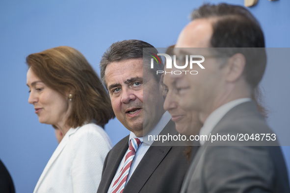Foreign Minister Sigmar Gabriel (C), Justice Minister Heiko Maas (R) and Family Minister Katarina Barley (L) attend a news conference to ill...