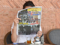 A person reads 'Al Michaal' - an Arabic-speaking Moroccan daily, reporting on yesterday's violent demonstrations and riots that took place i...