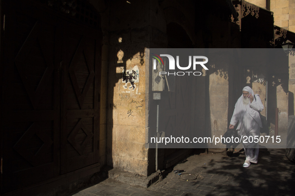 A man walks through the streets of Khan el-Khalili during the holy month of ramadan in Cairo on June 13, 2017 