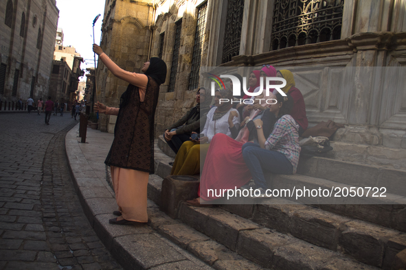 A grupe of women takes a selfie in Khan el-khalili district in Cairo on June 13, 2017 