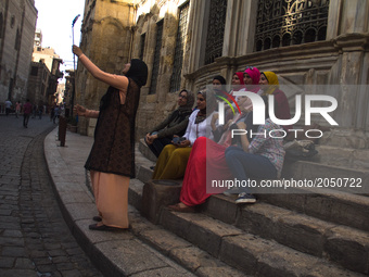 A grupe of women takes a selfie in Khan el-khalili district in Cairo on June 13, 2017 (