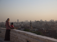 A woman and her son are watching the sunset from Al-Azhar park in Cairo on June 9, 2017 (