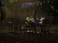 A grupe of man are having coffee in a popular district in Cairo on June  12, 2017 (