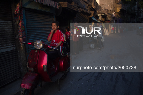 A kid in a motocycle is posing for a picture in Old Cairo on June 15, 2017 