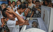 Relatives mourn over the coffin of sixteen year old Arjay Suldao, who was killed by unknow...