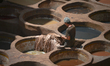 A worker inside a traditional Chouara Tanneries in Fes Medina.Leather tanneries in Morocc...