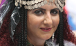 An Afghani woman dressed in traditional attire takes part in a multi-cultural Canada Day c...