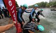 Competitors dive in the Bassin de La Villette during the swim section of the 2017 edition...