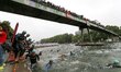 Competitors dive in the Bassin de La Villette during the swim section of the 2017 edition...