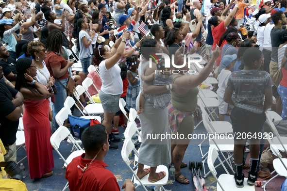 The crowd gets up on their feet at the WaWa Welcome America Independence Day concert on the Benjamin Franklin Parkway, in Philadelphia, PA,...