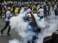 Demonstrator throw a tear gas bomb. Caracas on Wednesday 7 of June.  This July 9th, Venezuela will reach 100 days of protest against the gov...