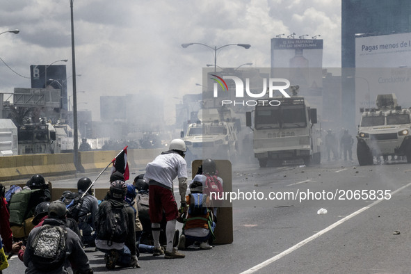Demonstrators face security forces in a highway during a rally. Caracas on Monday 19 of June.  This July 9th, Venezuela will reach 100 days...