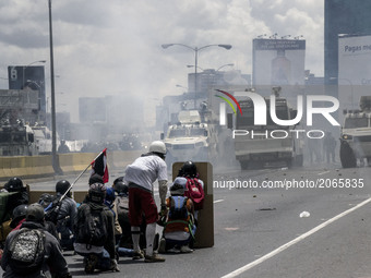 Demonstrators face security forces in a highway during a rally. Caracas on Monday 19 of June.  This July 9th, Venezuela will reach 100 days...
