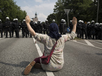 Germany, Hamburg: A woman sits in front of german riot police during protests  during the G20 summit in Hamburg, Germany, on July 7, 2017. (