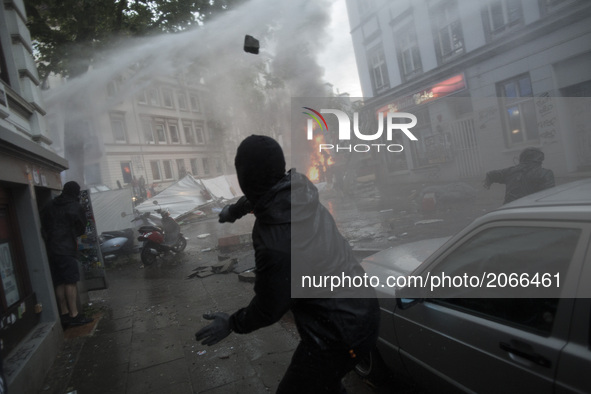Germany, Hamburg: Riot police use water cannons during protests in Hamburg's Schanzenviertel district  during the G20 summit in Hamburg, Ger...
