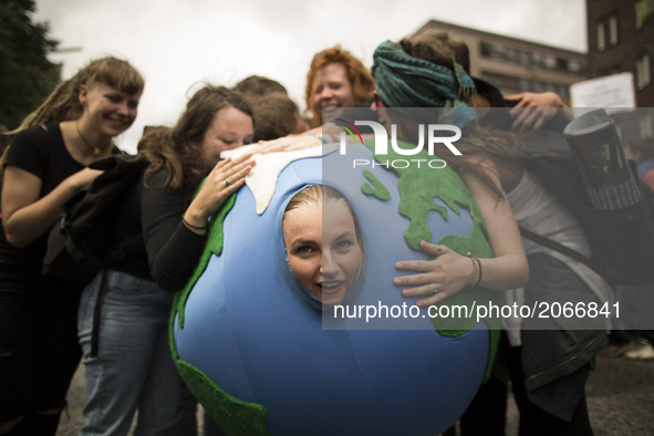 Germany, Hamburg:  A woman dressed  with a costume representing the world is embraced by people during the 'Hamburg Shows Attitude' demonstr...