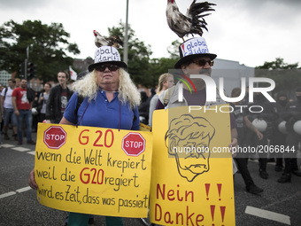 Germany, Hamburg: Protestors show political placards during the 'Hamburg Shows Attitude' demonstration in Hamburg, Germany,  on July 8 2017....