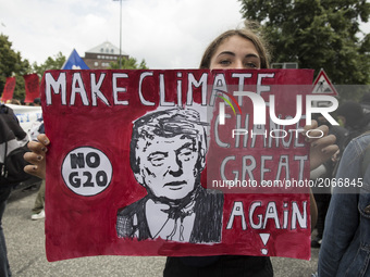 Germany, Hamburg: A woman shows a placard depicting Donald Trump during the 'Hamburg Shows Attitude' demonstration in Hamburg, Germany,  on...
