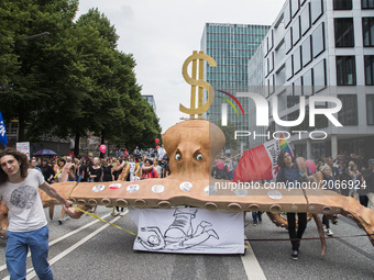 People pulling a huge octopus carrying portraits of G20 leaders attend a protest march against the G20 Summit with the topic 'Solidarity wit...