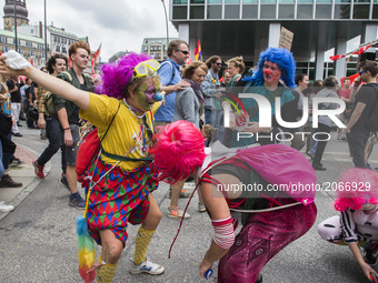 People dressed as clowns attend a protest march against the G20 Summit with the topic 'Solidarity without borders instead of G20' in Hamburg...