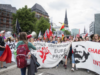 People attend a protest march against the G20 Summit with the topic 'Solidarity without borders instead of G20' in Hamburg, Germany on July...