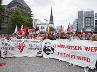 People attend a protest march against the G20 Summit with the topic 'Solidarity without borders instead of G20' in Hamburg, Germany on July...