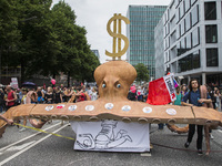 People pulling a huge octopus carrying portraits of G20 leaders attend a protest march against the G20 Summit with the topic 'Solidarity wit...