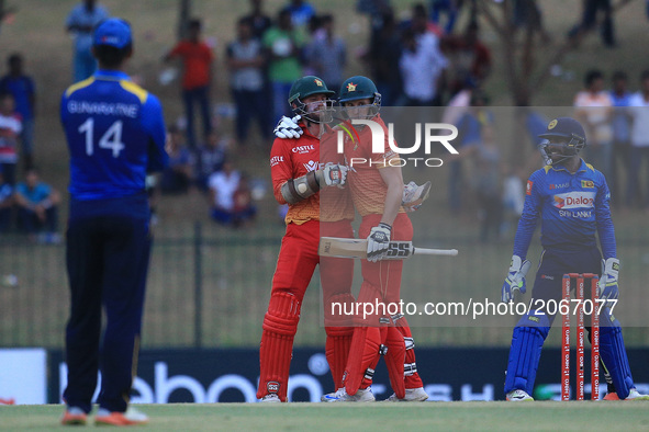 Zimbabwe's cricketer Craig Ervine and teammate Peter Moor celebrate after victory in the fourth one-day international (ODI) cricket match be...