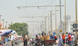 A view of a group of people crossing a tram path near the entrance to Rabat's medina.On F...