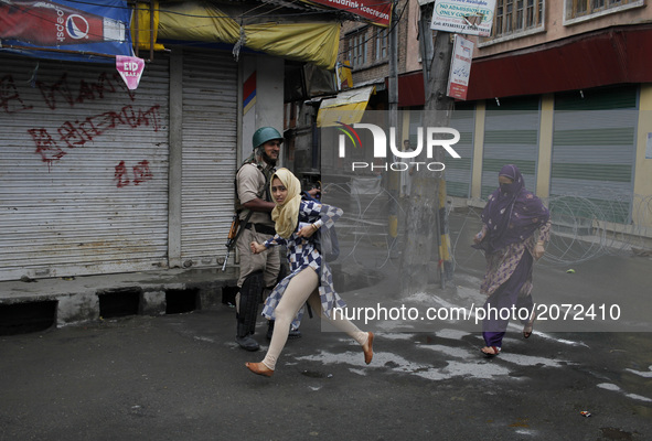 A kashmiri girl runs for cover during clashes in old city srinagar on july 12 ,2017.Anti-India protests and clashes erupted in the main city...