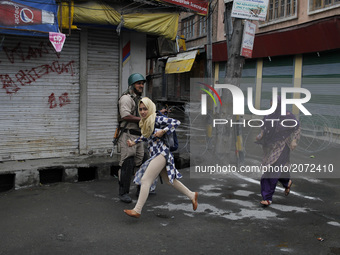 A kashmiri girl runs for cover during clashes in old city srinagar on july 12 ,2017.Anti-India protests and clashes erupted in the main city...
