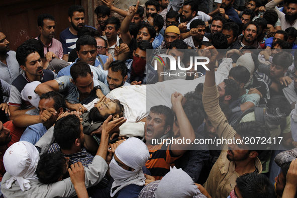 kashmiri people chant pro-freedom slogans  as they carry the body of  local pro-independence fighter  Sajad Ahmed Gilkar during his  funeral...
