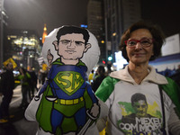 People celebrate in Sao Paulo, Brazil, July 12, 2017, after Brazil's former president Luiz Inacio Lula da Silva was sentenced to nearly 10 y...