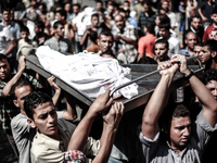 Palestinians carry the body of a member of the Abu Nejim family, whom medics said was killed along with other eight family members by an Isr...