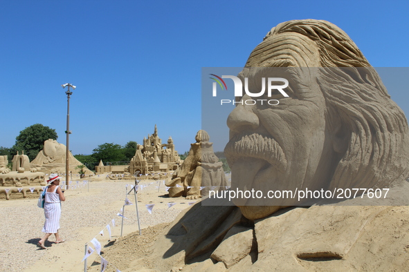 Visitors walk past sand sculptures during the 10th international sand sculptures festival in the Bulgarian town of Burgas east of the capita...