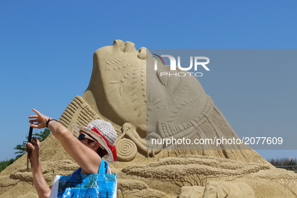 Visitors walk past sand sculptures during the 10th international sand sculptures festival in the Bulgarian town of Burgas east of the capita...