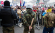Guard holds a baseball bat during a mass demonstration on Sunday.The protest on Kiev‚??s...