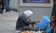 An elderly woman searches a rubbish bag to find some food in Ankara, Turkey on July 16, 20...