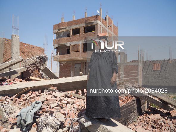 An Egyptian woman standing in front of a destroyed house in al-Warraq Island, Giza, Egypt, 18 July 2017. Clashes broke at the island of al-W...