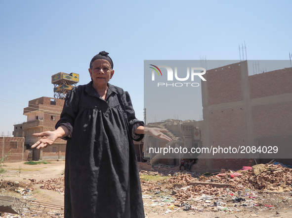 An Egyptian woman  standing in front of a destroyed house in al-Warraq Island, Giza, Egypt, 18 July 2017. Clashes broke at the island of al-...