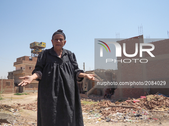 An Egyptian woman  standing in front of a destroyed house in al-Warraq Island, Giza, Egypt, 18 July 2017. Clashes broke at the island of al-...