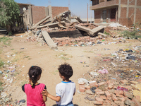 Two Egyptian children, family standing in front of a destroyed house in al-Warraq Island, Giza, Egypt, 18 July 2017. Clashes broke at the is...