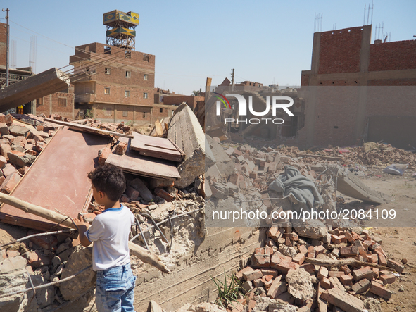 An Egyptian children looks a destroyed house in al-Warraq Island, Giza, Egypt, 18 July 2017. Clashes broke at the island of al-Warraq after...