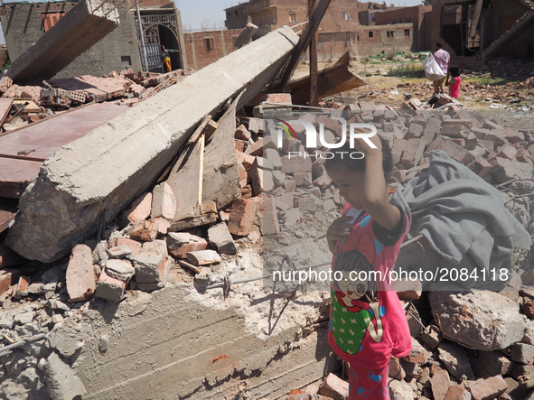 An Egyptian woman, children, family standing in front of a destroyed house in al-Warraq Island, Giza, Egypt, 18 July 2017. Clashes broke at...