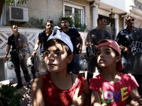 Refugee boys and riot police officers, during a protest rally, close to the German embassy in Athens on Wednesday 19 July 2017. Refugees, ma...