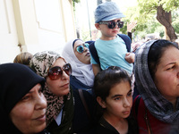 Mothers with their children protest outside the German embassy in Athens on Wednesday 19 July 2017. The refugees, mainly Syrians from the re...