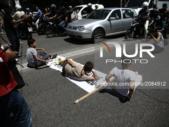 Refugee children block the street, during a protest close to the German embassy in Athens on Wednesday 19 July 2017. Refugees, mainly Syrian...